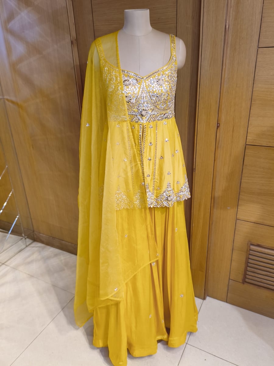 Yellow mirror-work peplum set with dupatta on a mannequin