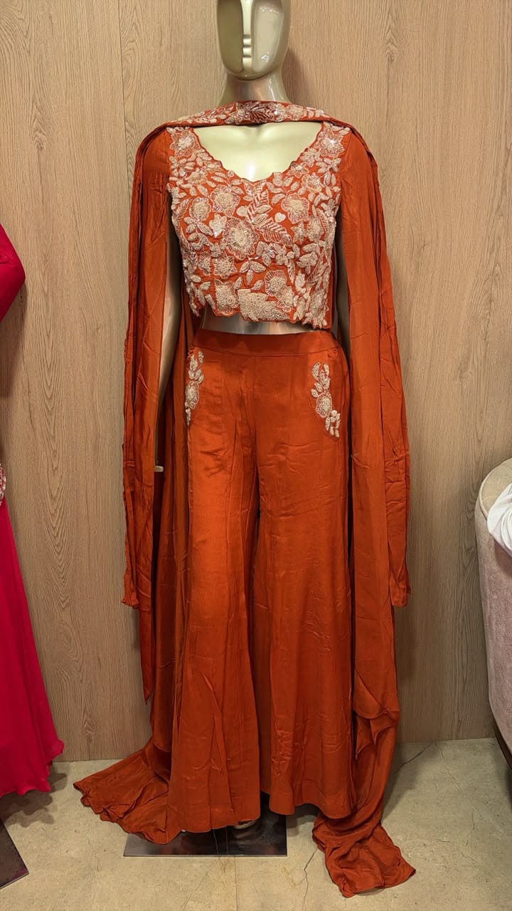 Rust embroidered crop top, palazzo and cape on a mannequin